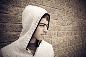 Disenchanted teenage boy wearing a hooded top